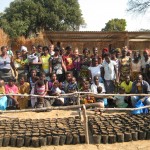 Color Me In Sarah_and_Ned_with_Women's_CMi_Loan_group_keeping_Pigs_and_Planting_trees